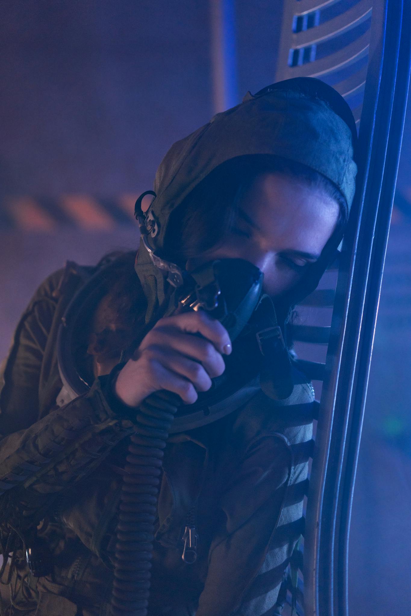 Woman in space suit using breathing apparatus in a sci-fi environment. Futuristic and interstellar theme.